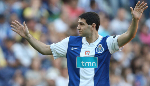 Person wearing a Porto sports jersey with visible branding in a stadium setting