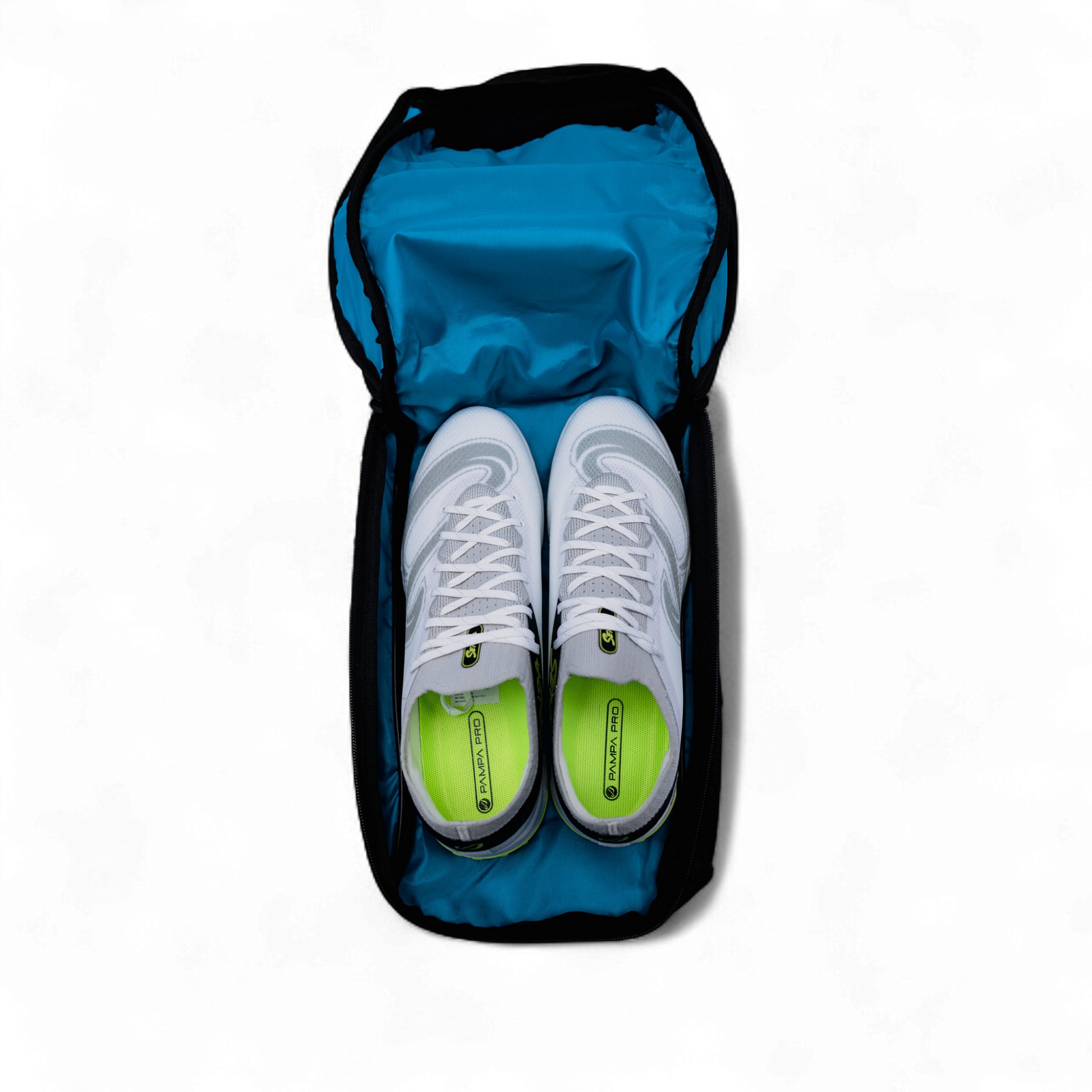 White sneakers with green soles in a blue shoe bag on a white background