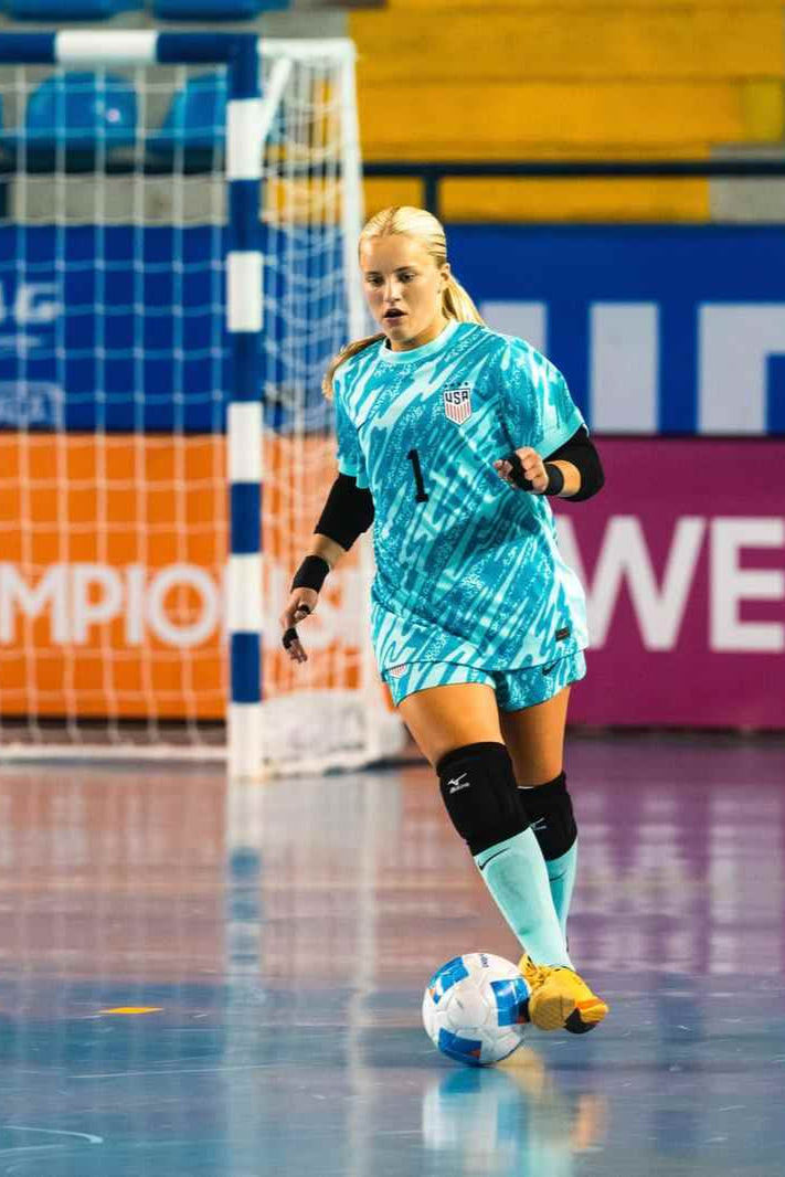 Woman playing futsal on a court
