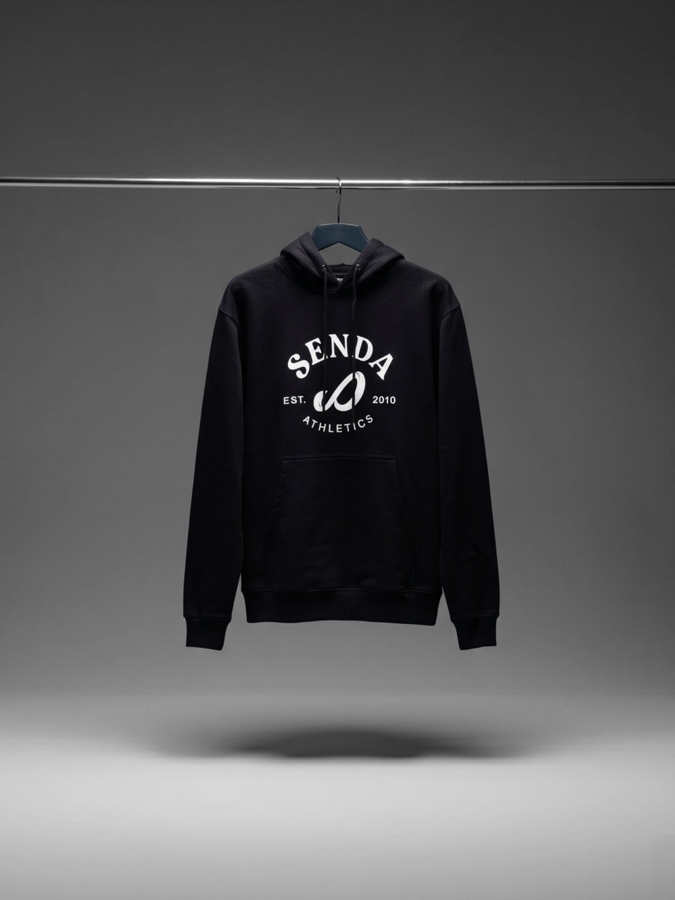 Black hoodie with 'Senda' logo on a gray background. Senda Lifestyle Apparel Collection