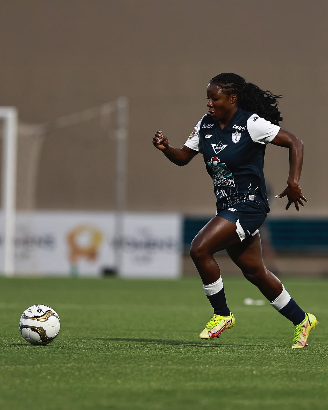 Soccer player in action on a field with a blurred background