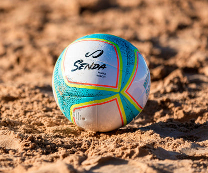 Colorful beach soccer ball with 'Senda' branding on a sandy surface