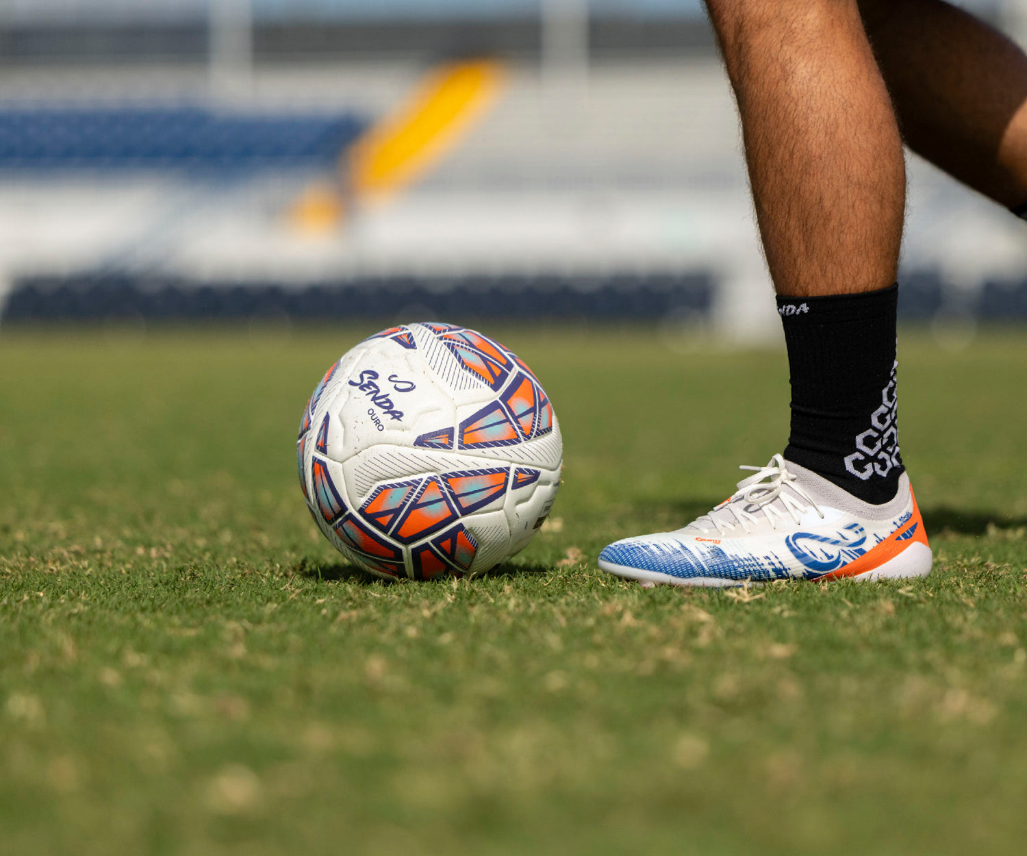 Soccer ball and foot on a grass field