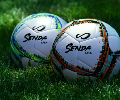 Two Senda Apex soccer balls on grass