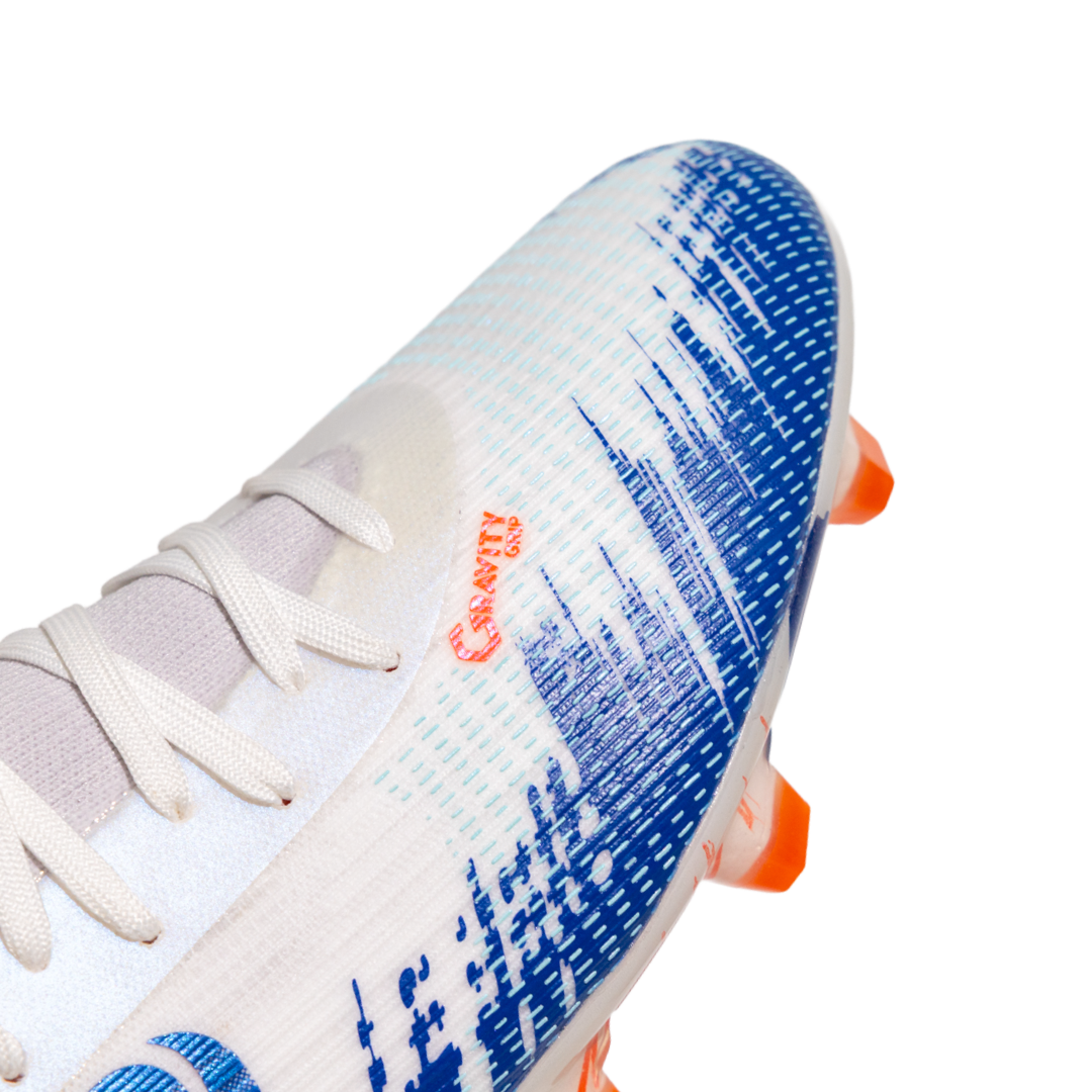 White soccer cleat with blue pattern and orange accents on a white background with Senda Gravity  Grip technology